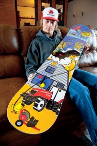 Mitch shows off one his most prized boards, complete with a drawing of a Massey Ferguson tractor.