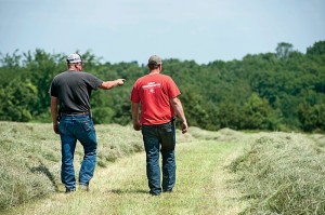 Hammann walks with his son, Jason, who kicks in some much-needed help at harvest time.