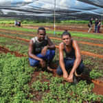 Vivero Alamar employees Ronnier and Alfredo with mint plants.